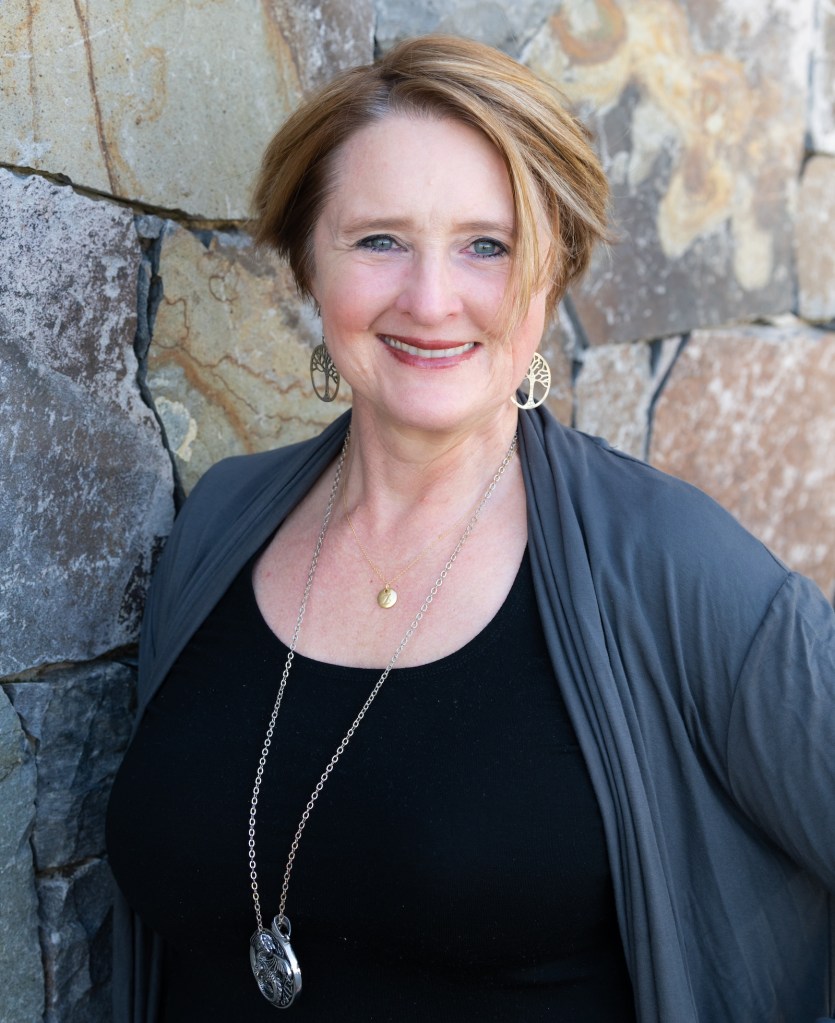 Zoë listening to whispers in the wall (Image and caption credit: Zoë Routh)