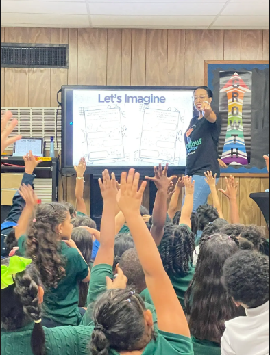 Tiffany Obeng in a classroom with pupils